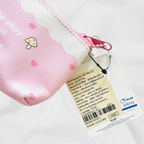 A My Melody pencils case and a close-up of its Sanrio label, with the product's information tag written in Thai. 