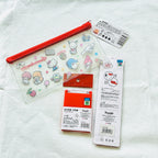 A back view of the Sanrio Hello Kitty themed personal care set. Show the licensed holographic sticker of the compact mirror and a comb. 