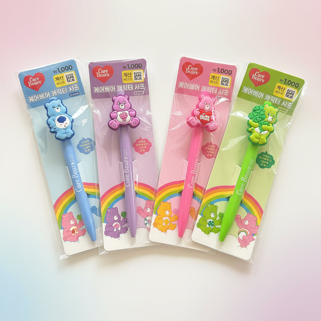 Four packaged Care Bears themed ballpoint pens in blue, pink, and green, each featuring a bear character on the pen top and a rainbow design on the card backing.