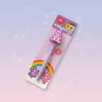 A Care Bears themed 1000-line pen in its original packaging, featuring a lavender pen with a pink bear character topper and colorful rainbow graphics on a pastel gradient background.