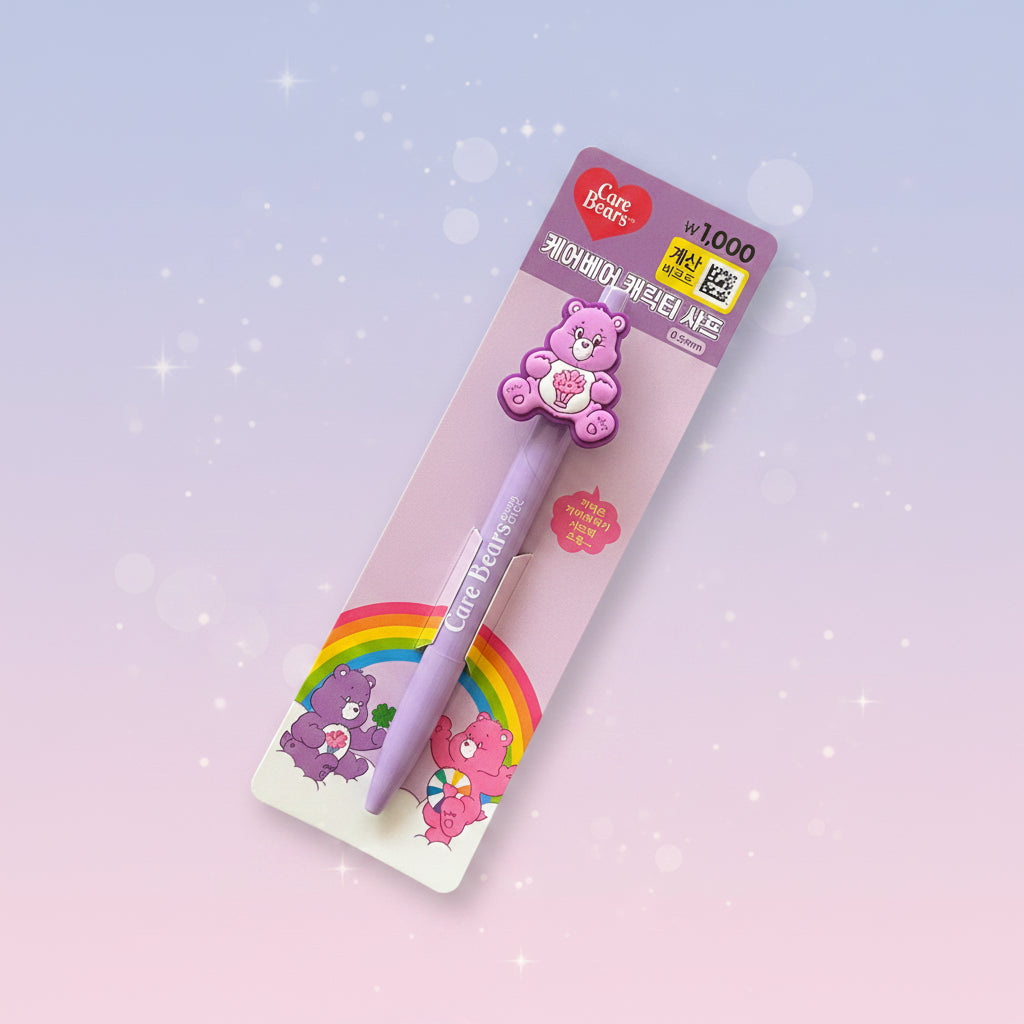 A Care Bears themed 1000-line pen in its original packaging, featuring a lavender pen with a pink bear character topper and colorful rainbow graphics on a pastel gradient background.