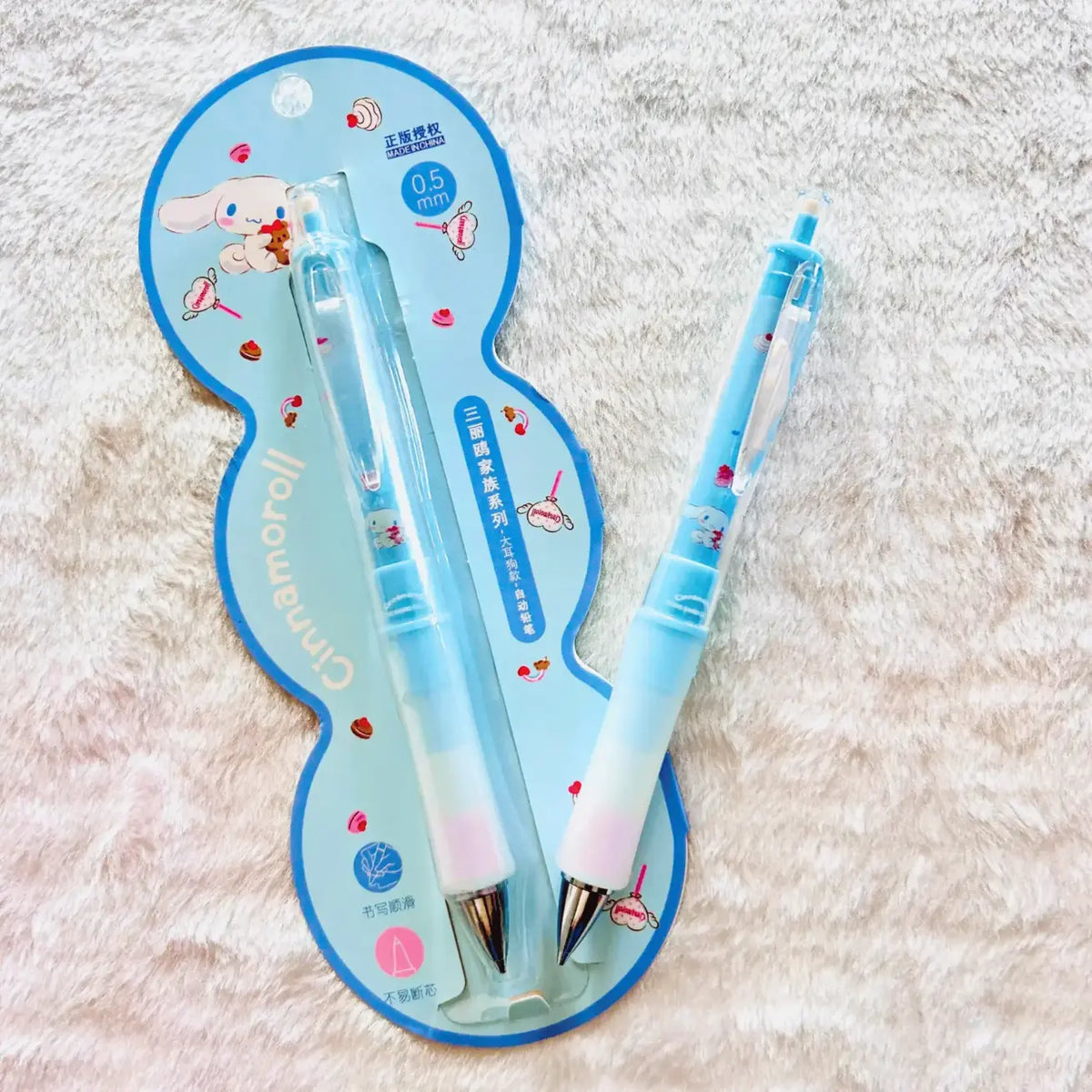 Two Cinnamoroll mechanical pencils in a light blue and white gradient, displayed on their original blue and white packaging card.
