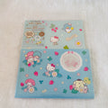 A stack of Sanrio Hello Kitty and Sanrio Cinnamoroll Letter Set, shows the product packaging with a Hello Kitty strawberry-themed design, and the bottom sheet displays the actual sticker collection featuring Hello Kitty, My Melody, Cinnamoroll, and a blue penguin.