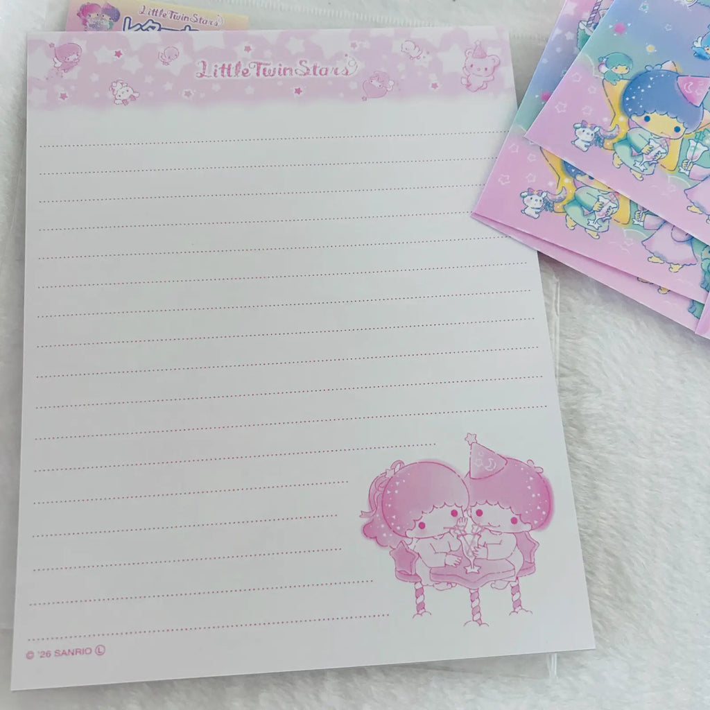 A pink lined notepad with 'Little Twin Stars' printed at the top and a cute character illustration in the lower right corner, shown on a white textured surface with other matching stationery cards partially visible.