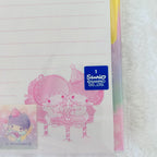 Sanrio Two-Little Stars themed lined notepad sheet with a blue Sanrio logo sticker and character illustration, photographed on a white textured surface.