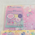 A Little Twin Stars letter set stationery package with pastel pink and blue packaging, shown on a white textured background. The set includes letter paper, envelopes, stickers, and a sheet of star stickers.