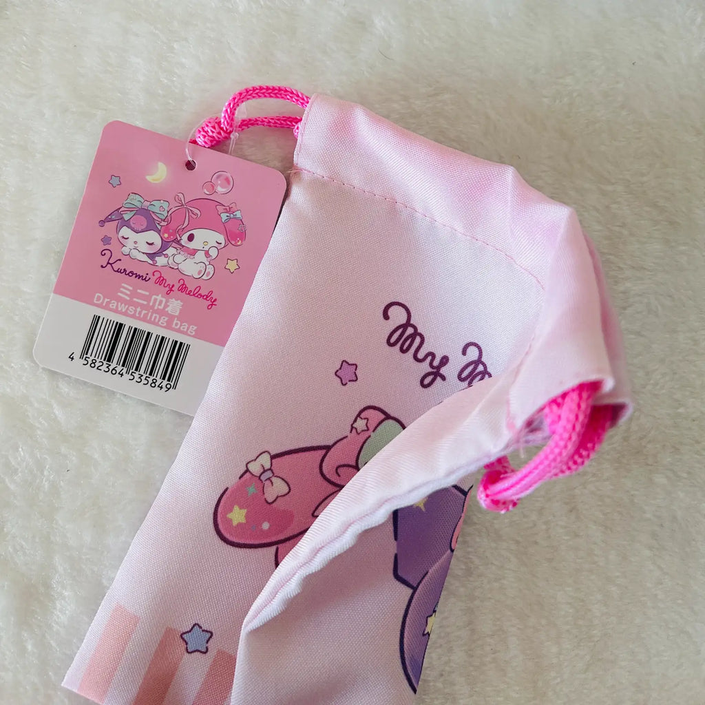 A light pink drawstring pouch with a cartoon character print and a pink hangtag, photographed on a soft white textured surface. The tag shows Sanrio's My Melody branding.