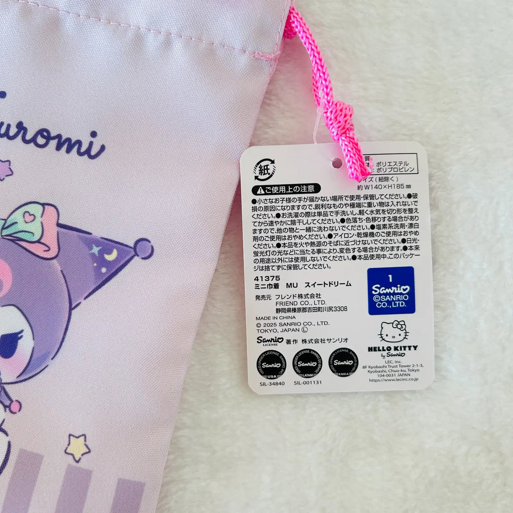 Close-up of a Sanrio Hello Kitty and Kuromi product tag attached to a light pink fabric item with a bright pink drawstring, on a white textured background.