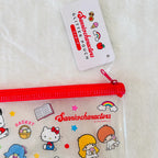 A clear plastic zippered pouch with a red zipper and Sanrio characters printed on it, shown with a white hangtag that reads 'Glitter Pouch Sanriocharacters.'  
