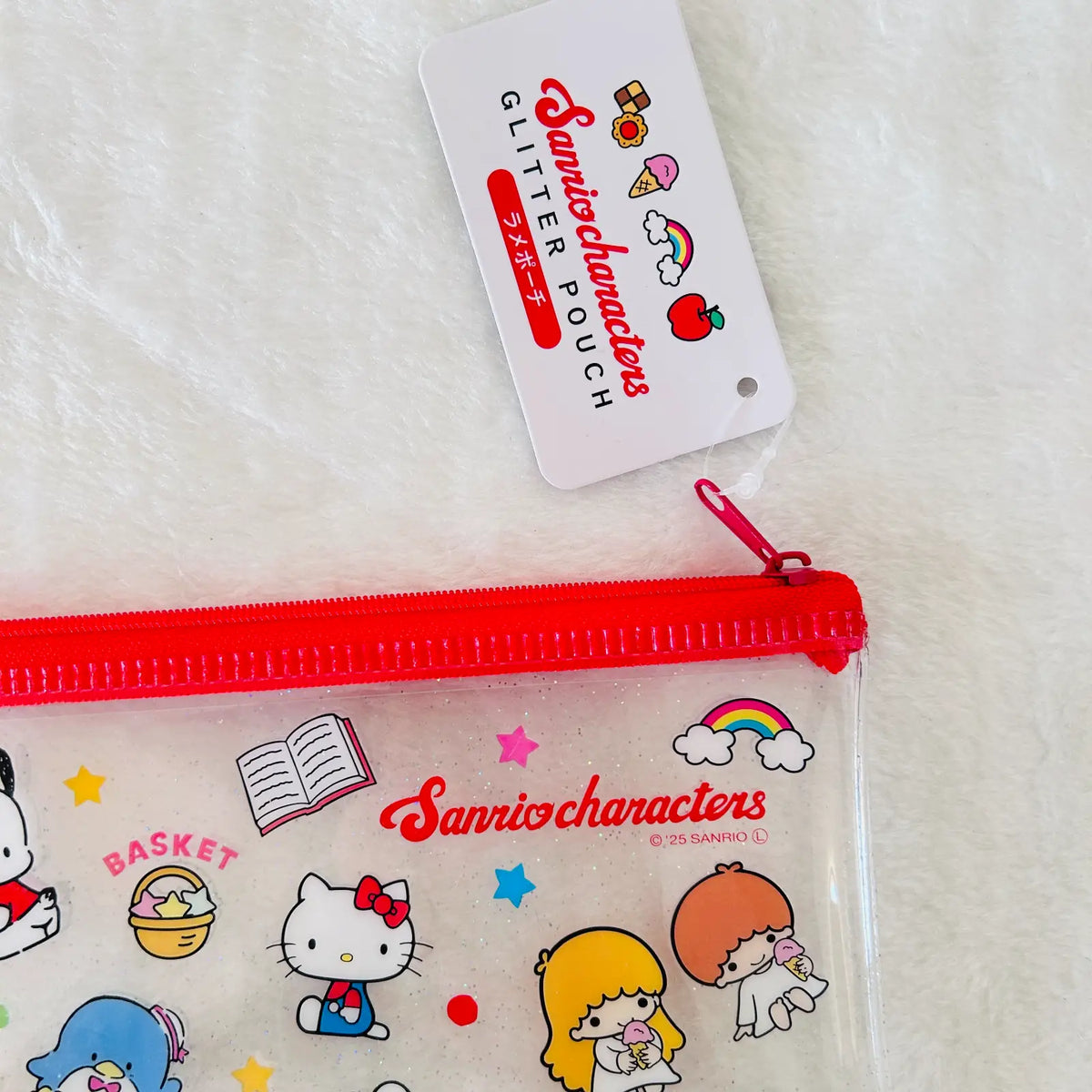 A clear plastic zippered pouch with a red zipper and Sanrio characters printed on it, shown with a white hangtag that reads 'Glitter Pouch Sanriocharacters.'  