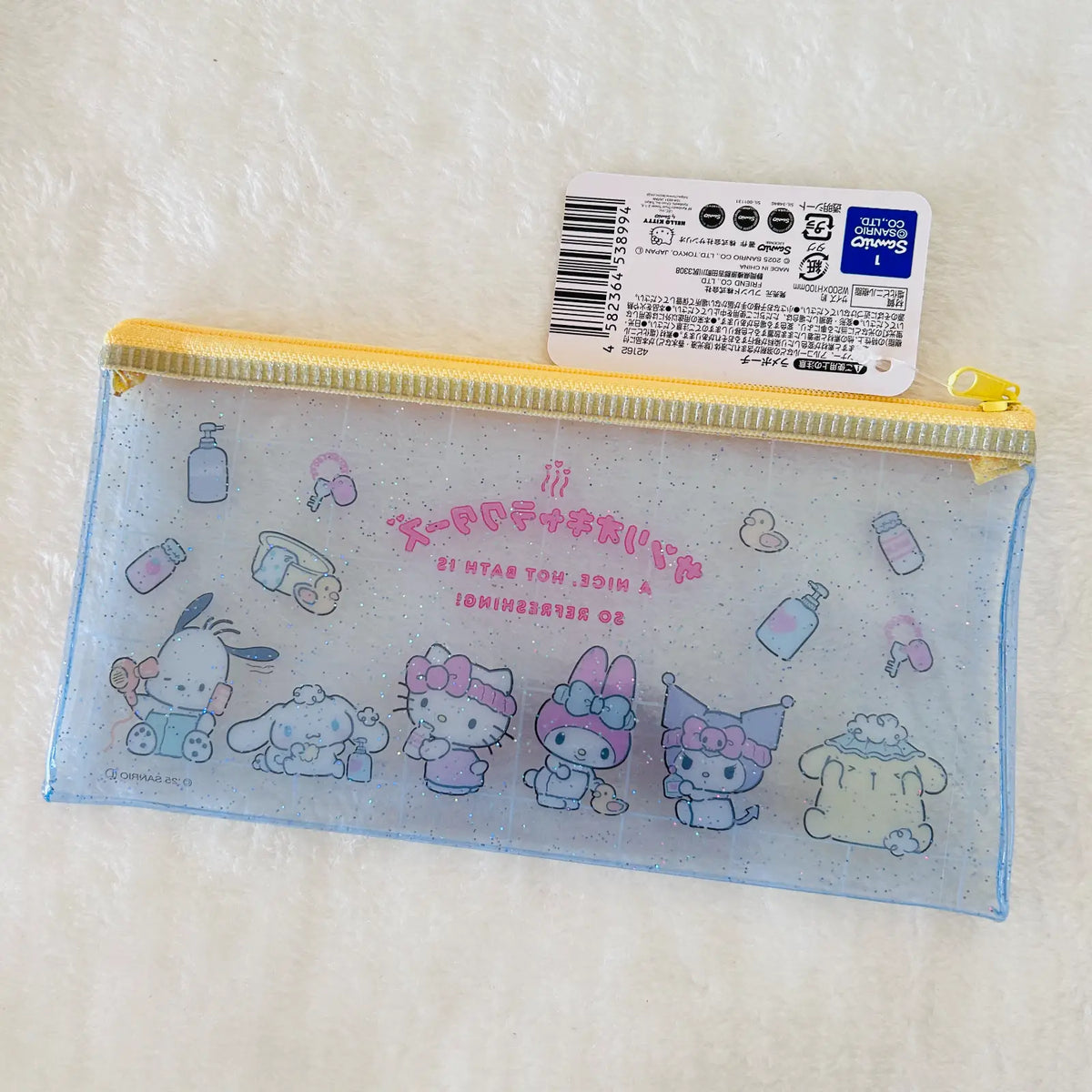 A translucent light blue zippered pencil case with Sanrio character prints, shown with its original retail tag on a white textured background.
