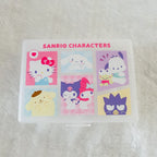 A clear plastic storage box with a printed Sanrio Characters design on the lid, featuring six cartoon panels and the text 'SANRIO CHARACTERS' in pink, placed on a white textured surface.