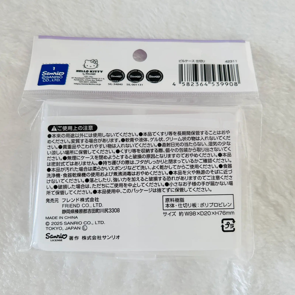 A packaged Sanrio Hello Kitty product in a clear plastic bag with a printed white backing card. The card shows the Sanrio and Hello Kitty logos, a barcode, and multiple lines of Japanese warning and product information.