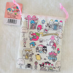A Sanrio-themed drawstring pouch featuring colorful cartoon character illustrations, shown with its pink hangtag on a soft white textured background.