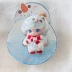 A Dimoo plush doll in a clear blister pack on a Snowman shaped backing card.