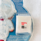 A packaged of Dimoo Snowman plush toy, shows a small red label on the package reads 'POP MART' with QR code.