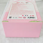 Pink product packaging box with a large white label containing red text, barcodes, and small cartoon floral details on the front and top, photographed on a white textured surface.