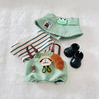 A set of miniature doll clothing accessories including a mint green romper, a striped top, a matching mint green skirt, and black doll shoes.