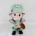 A cute plush doll with a light green bunny hat, striped shirt, green overalls, and black shoes, standing against a white background.
