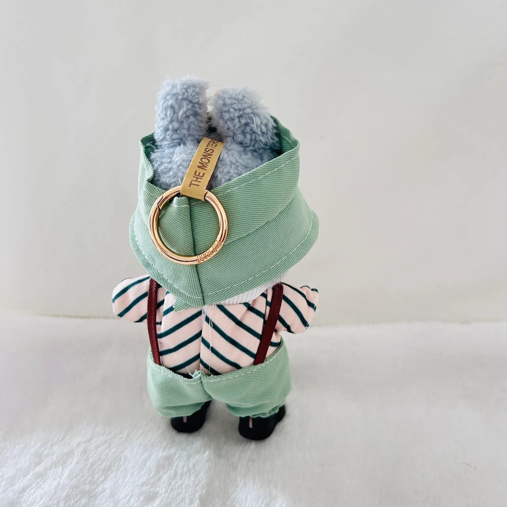A Labubu dressed in a mint green waistcoat and striped shirt.