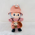 A Labubu plush doll wearing a dusty coral bucket hat, red-and-white striped shirt, dusty coral overalls, and black boots.