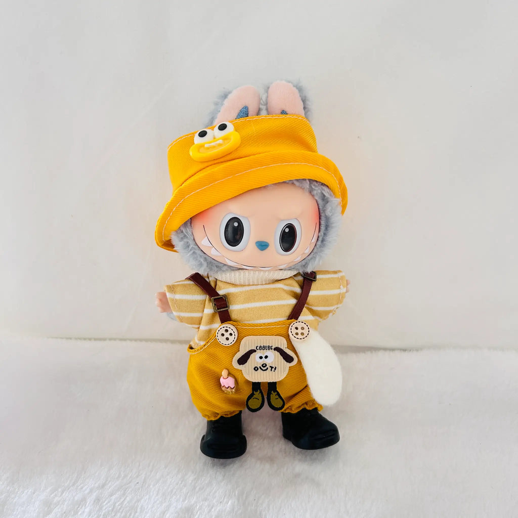 A Labubu plush doll dressed in a yellow outfit with a striped shirt, brown suspenders, black boots, and a yellow bucket hat.