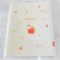 A translucent white plastic file folder featuring Hello Kitty designs, including a central apple illustration, 'Hello Kitty' text, small hearts, bows, and apples.