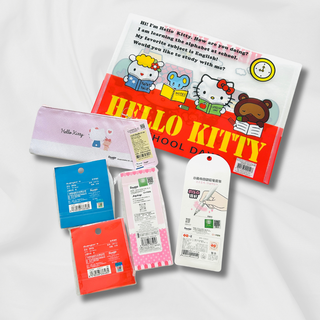 A Hello Kitty school accessory set arranged on a white background, including a large red-and-white school bag with Hello Kitty graphics, a pink pencil case, and several small packaged items in blue, pink, and red.