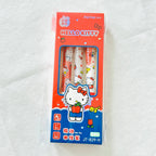 A pack of three Hello Kitty mechanical pencils in their original retail packaging, displayed on a white textured fabric background.