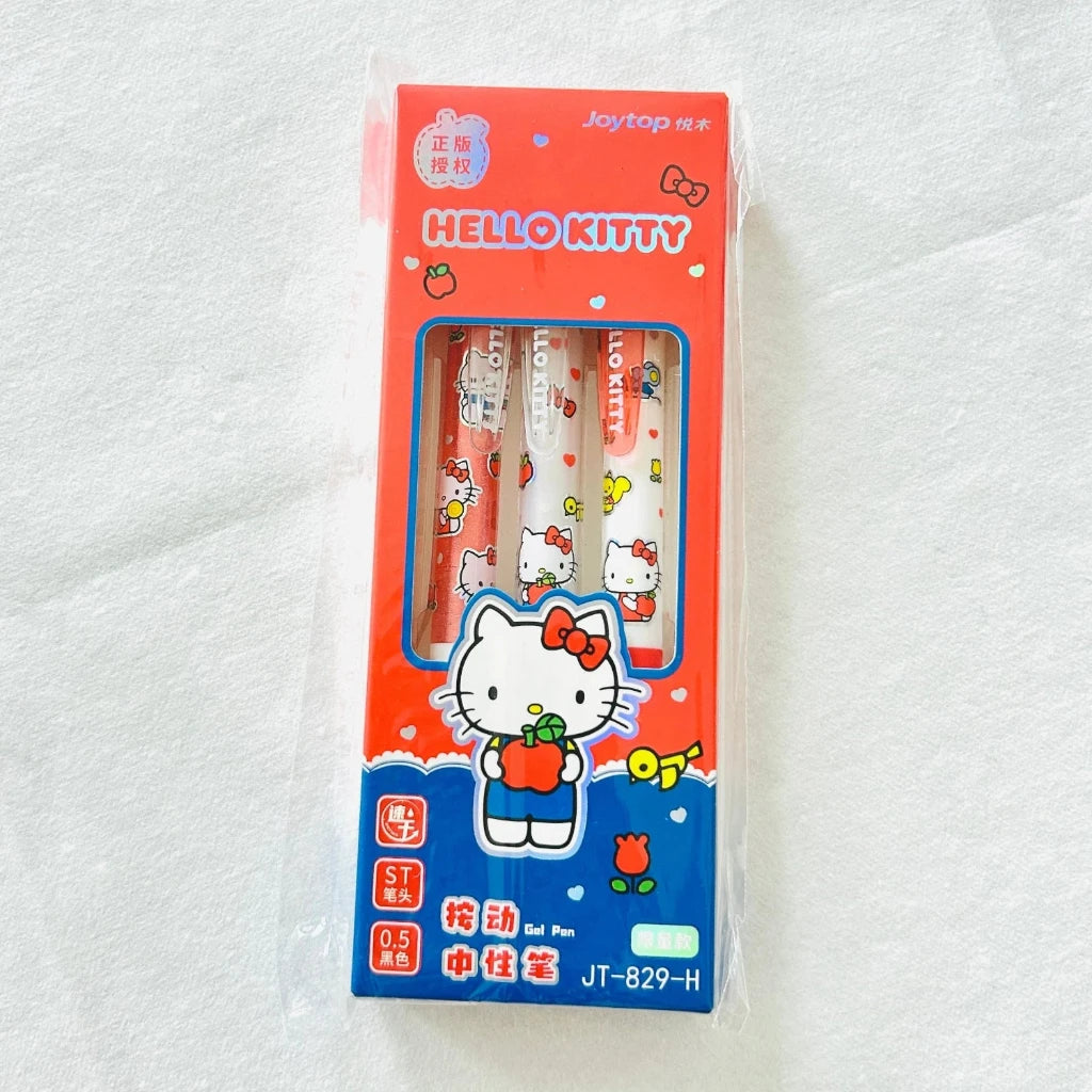 A pack of three Hello Kitty mechanical pencils in their original retail packaging, displayed on a white textured fabric background.
