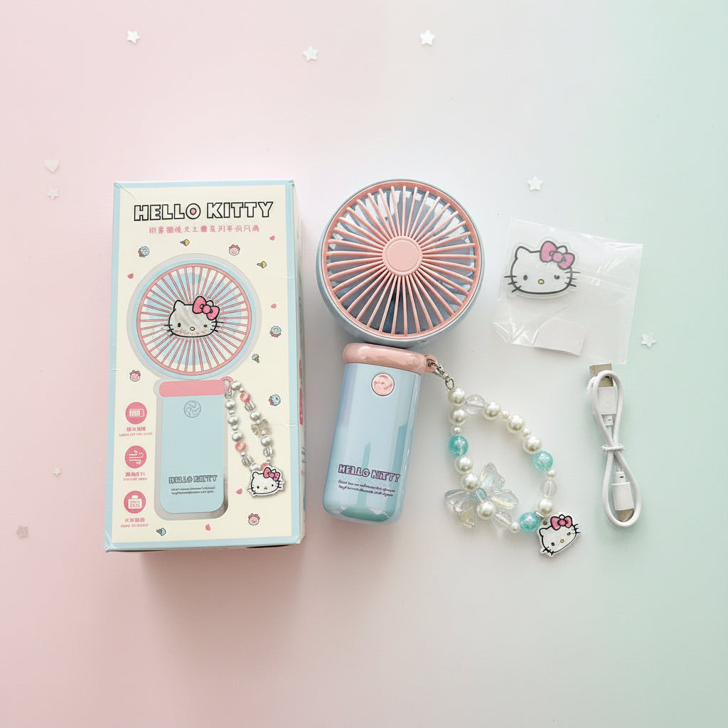 Hello Kitty portable handheld fan set with its retail box, featuring a pastel pink and light blue fan, a matching beaded wrist strap with a Hello Kitty charm, a USB charging cable, and a small Hello Kitty card.