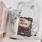 A sealed white package bag with cute character illustrations and a large 'Mist-Walker' label.