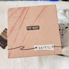 A top view of a paper box with a black 'POP MART' logo.