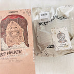A Pop Mart product package box, text includes 'HIRONO' and 'MIST-WALKER', next to a white package bag.