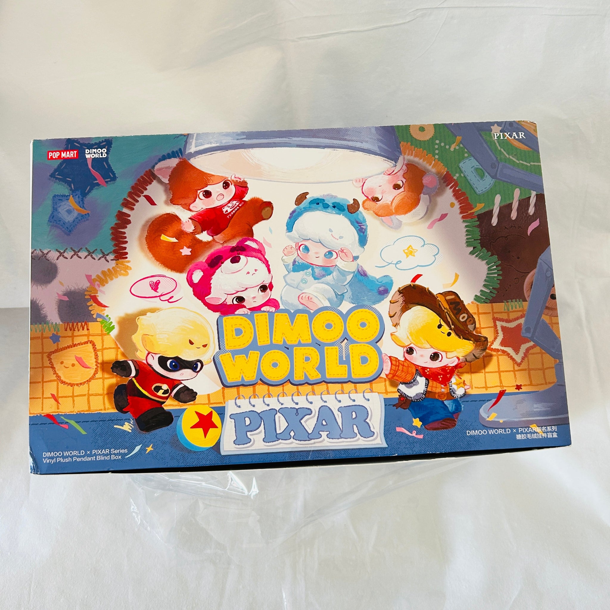 Pop Mart Dimoo World Pixar collectible figure box, featuring colorful cartoon characters and the Pop Mart and Pixar logos on a white fabric background.
