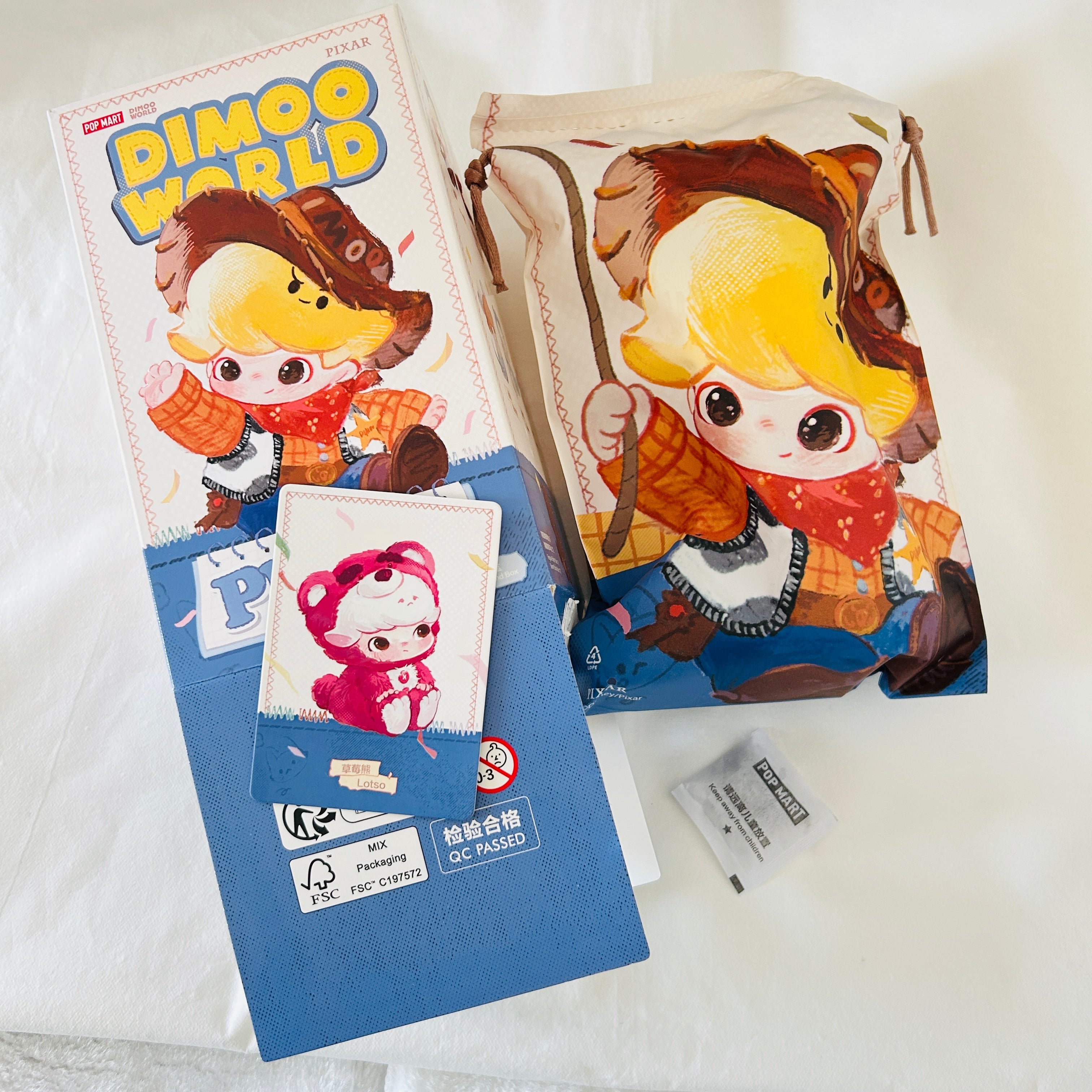 A Disney Pixar Dimoo World collectible figure plush pendant product box. Opened from the bottom and shows a card of Lotso.