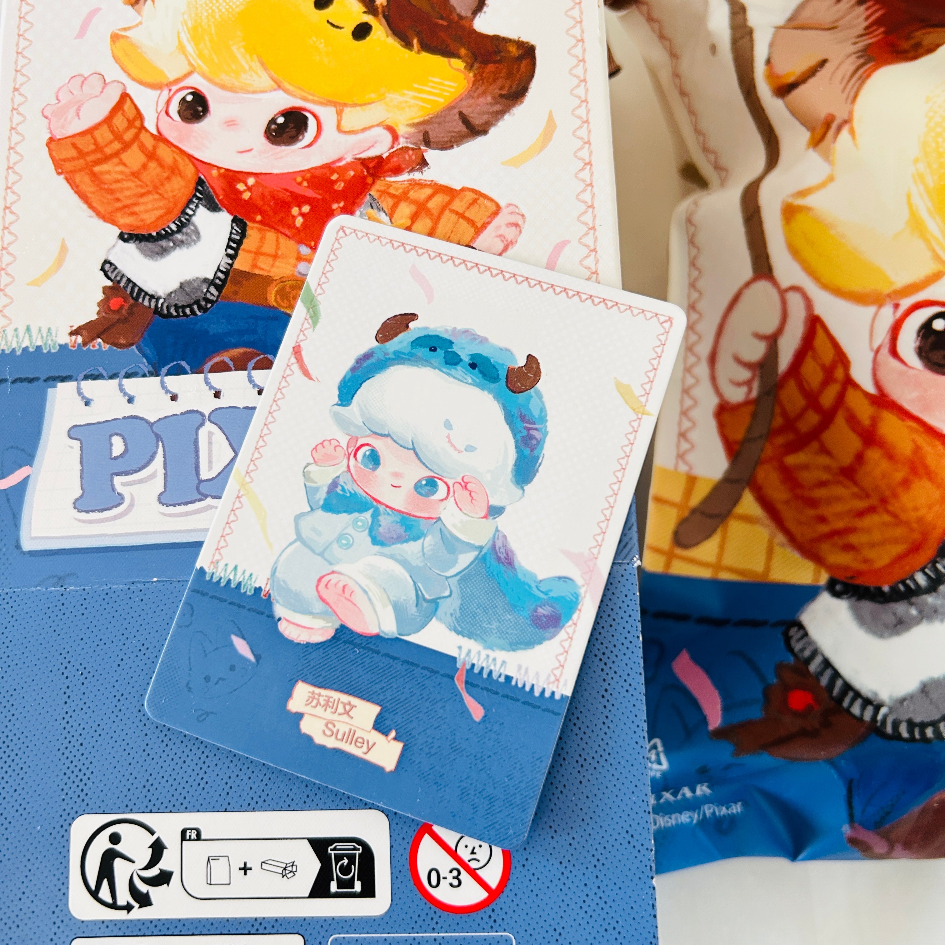 A Disney Pixar Dimoo World collectible figure plush pendant product box. Shows a close-up view of the card of Sulley.