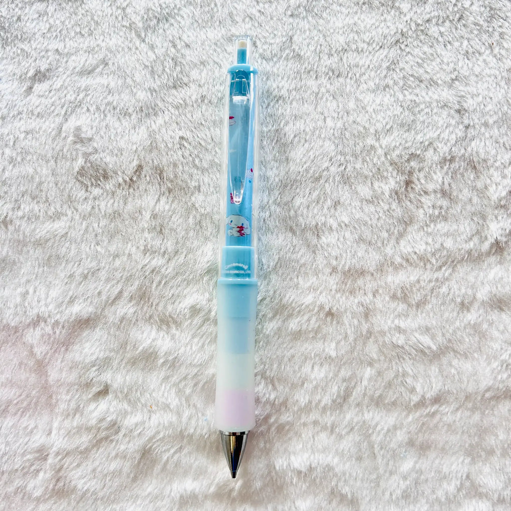 A light blue and white gradient gel pen with small red and blue floral details, lying on a white textured faux fur surface.