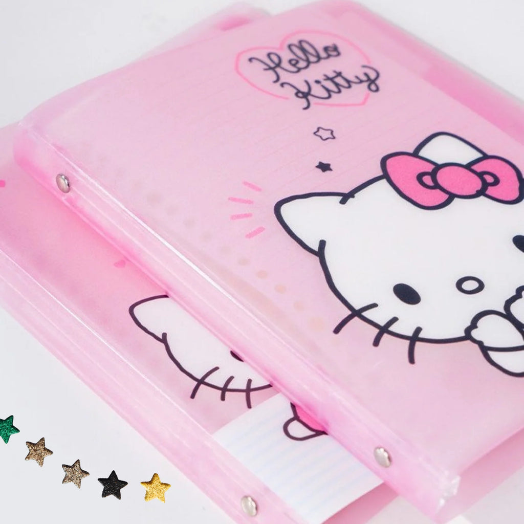 A translucent pink Hello Kitty notebook or planner cover with a cartoon cat face, pink bow, and Hello Kitty text, shown on a white background with small star-shaped embellishments at the bottom left.