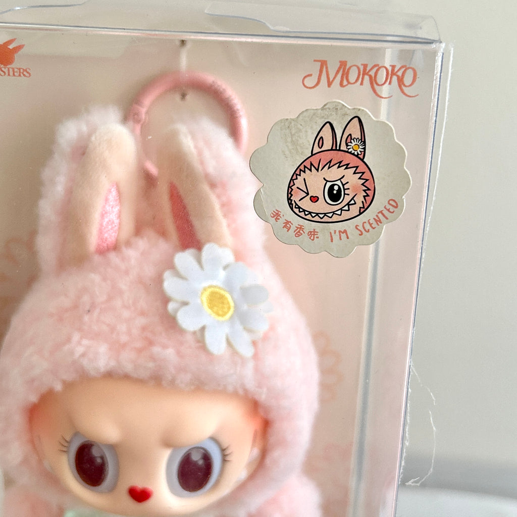 A clear plastic box, featuring a round character sticker that reads 'MOKOKO' and 'I'M SCENTLY'.