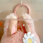 A close-up of a Labubu Mokoko ears, a white daisy flower with a yellow center, and a pink ring clasp at the top.