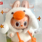 A Pop Mart Forest Fairy Tale collectible plush toy inside its original clear plastic packaging box, featuring a character in a white bunny costume with orange accents.