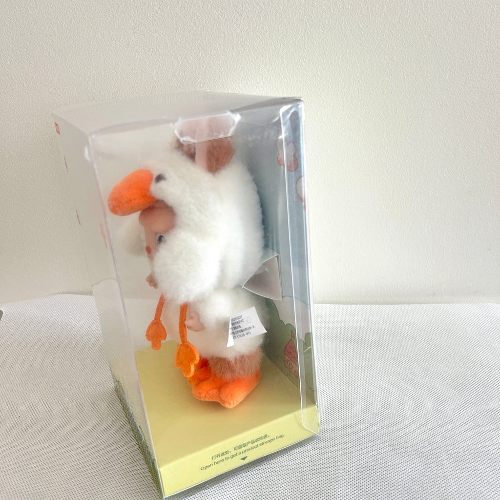 A close-up of the right side of a Labubu Forest Fairy Tale plush doll, which inside a clear package box.