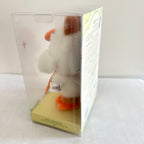 A close-up of the side of a Labubu Forest Fairy Tale plush doll which with white fur and orange feet. 