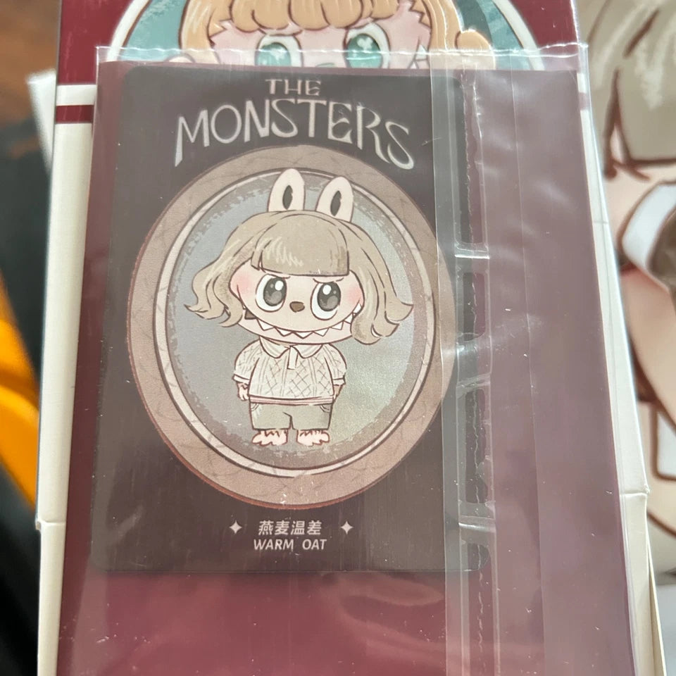 A collectible coin or charm featuring a cartoon rabbit character with the text 'THE MONSTERS' and 'WARM OAT' on its display card