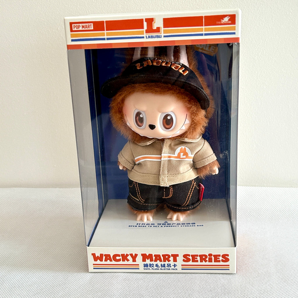 A front view of the side of a Labubu Wacky Mart Series plush doll, which with brown fur and wearing uniform. 
