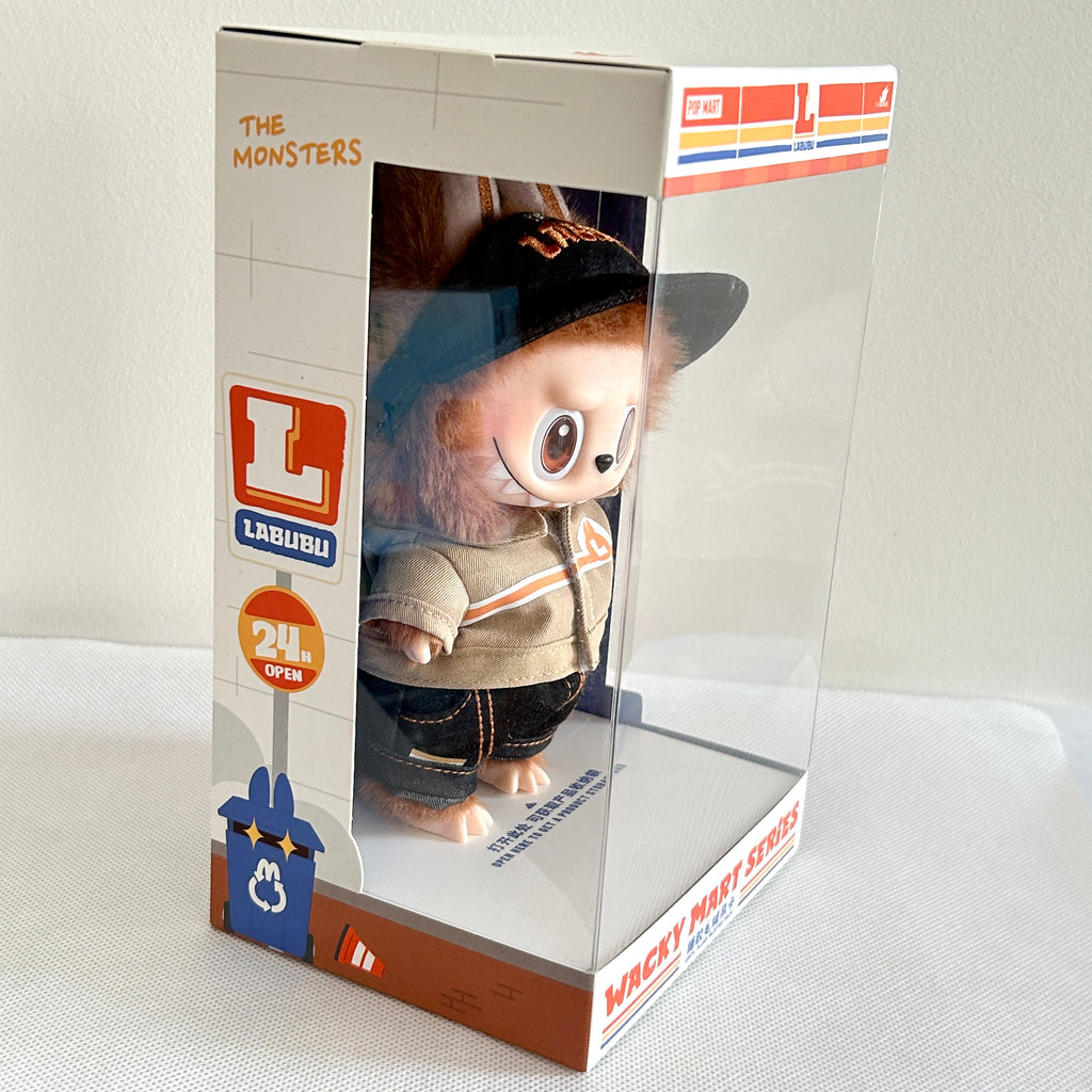 A packaged Labubu Wacky Mart Series plush, wearing a black baseball cap, beige jacket, and dark jeans.