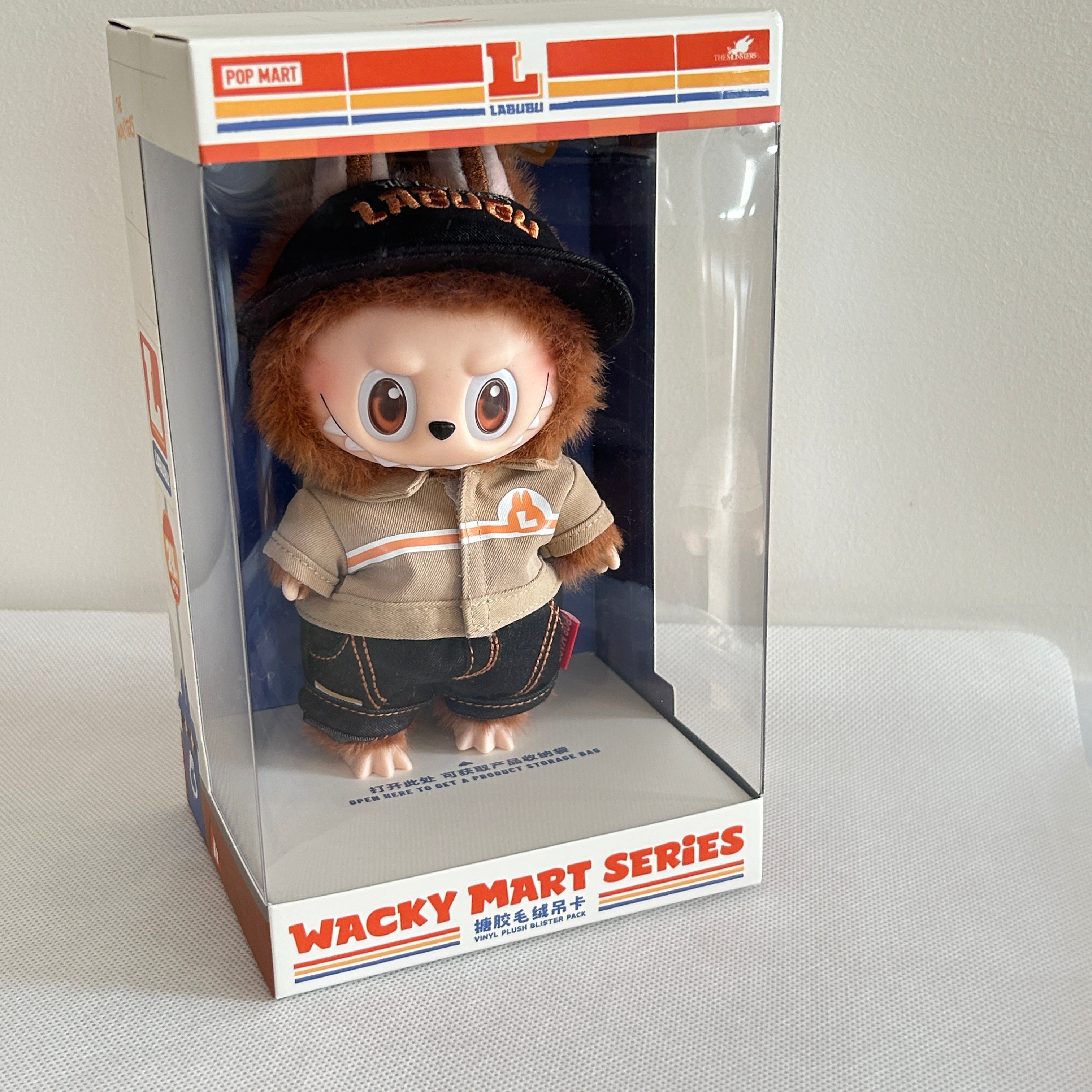 A Wacky Mart Series collectible plush figure inside its original retail packaging, displayed on a light-colored fabric surface.
