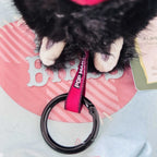 A close-up view of a Labubu plush toy chain ring with text of "POP MART".