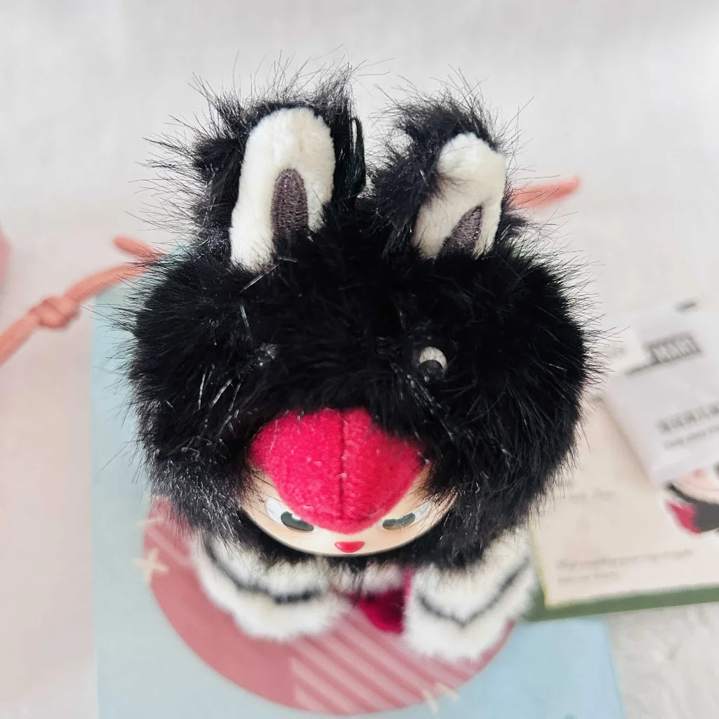 A top view of a Labubu Dive Into Love plush doll, shows it's black head and long ears.